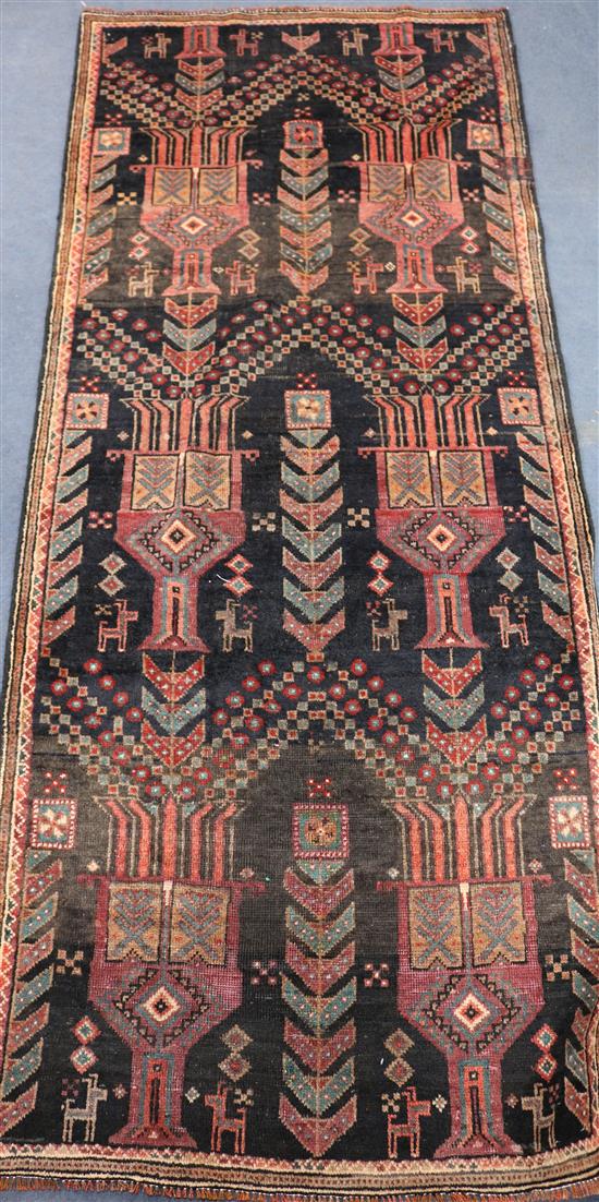 A Belouchi red and black ground rug, 7ft by 2ft 11in.